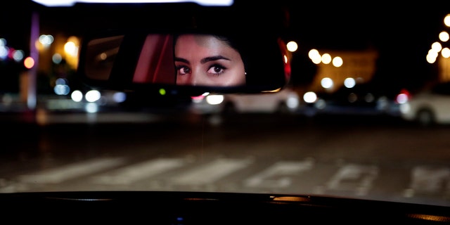 In this Sunday, June 24, 2018 file photo, Hessah al-Ajaji drives her car down the capital's busy Tahlia Street after midnight for the first time, in Riyadh, Saudi Arabia. 