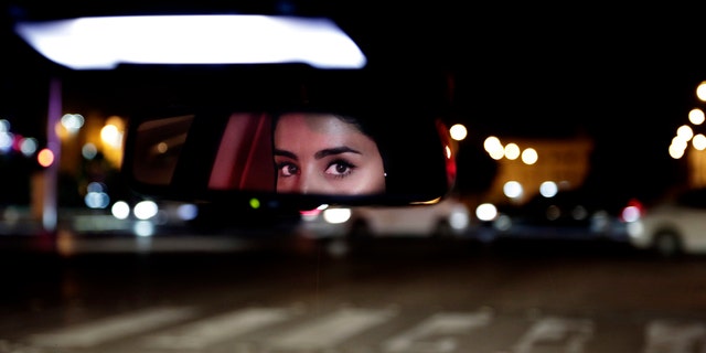 In this Sunday, June 24, 2018 file photo, Hessah al-Ajaji drives her car down the capital's busy Tahlia Street after midnight for the first time, in Riyadh, Saudi Arabia.