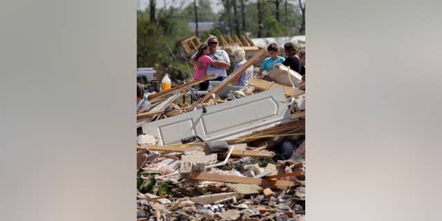 Residents and friends sift through debris after a tornado struck the area, Monday, April 28, 2014, in Vilonia, Ark. (AP Photo/Eric Gay)