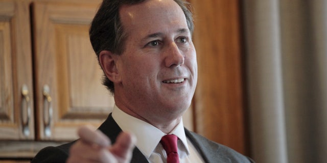 FILE 2016: Rick Santorum visits with supporters at a house party in West Des Moines.