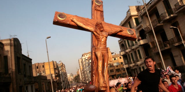 Angry Egyptian Christians protest outside St. Mark's Cathedral against the military ruling council in Cairo Egypt, Monday, Oct. 10, 2011 a day after at least 24 people were killed when Christians, angered by a recent church attack, clashed Sunday night with Muslims and security forces outside the state television building in central Cairo.