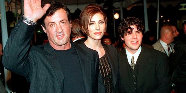Dec. 5, 1996: In this file photo, Sylvester Stallone, left, star of the film "Daylight," arrives at the film's world premiere with his girlfriend Jennifer Flavin, center, and his son Sage Stallone, who co-stars in the film, in Hollywood district of Los Angeles.