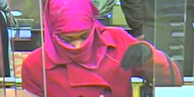 In this Monday, Dec. 2, 2013 surveillance photo, a woman appears inside a bank in Landover, Md. Prince George's County Police are looking for the woman who they say robbed the Capital One Bank on Annapolis Road in Landover. (AP Photo/Prince George's County Police Department)