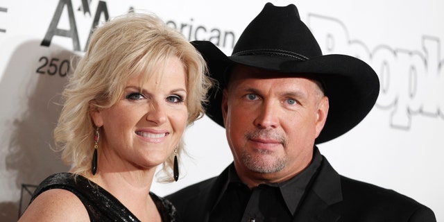 Singers Garth Brooks (R) and Trisha Yearwood pose as they arrive for the Songwriters Hall of Fame awards in New York June 16, 2011. REUTERS/Lucas Jackson (UNITED STATES - Tags: ENTERTAINMENT) - RTR2NR8A