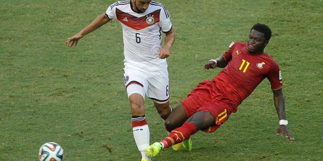 Germany's Sami Khedira, left, and Ghana's Sulley Muntari challenge for the ball during the group G World Cup soccer match between Germany and Ghana at the Arena Castelao in Fortaleza, Brazil, Saturday, June 21, 2014. (AP Photo/Themba Hadebe)
