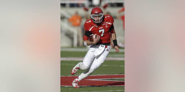 FILE - In this Nov. 9, 2013, file photo, Utah quarterback Travis Wilson carries the ball during an NCAA college football game against Arizona State in Salt Lake City. Wilson’s first goal this season is to stay healthy. (AP Photo/Rick Bowmer, File)