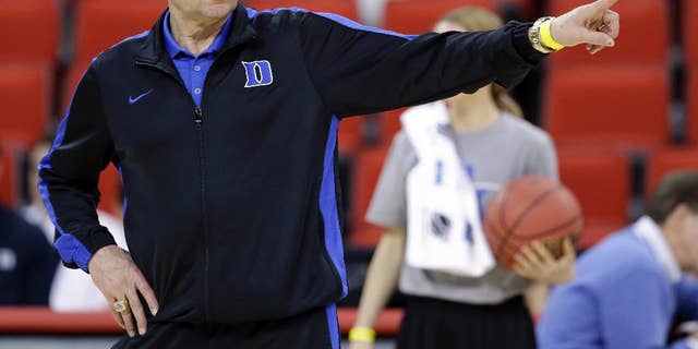 March 20, 2014: Duke head coach Mike Krzyzewski directs his team during practice at the NCAA college basketball tournament in Raleigh, N.C.