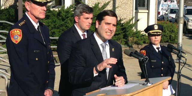 Suffolk County Police Commissioner Timothy Sini, center, addresses the media outside Police Headquarters in Bay Shore, N.Y., Friday, April 14, 2017. Police have identified the bodies of four young people discovered in a wooded area near a soccer field in Central Islip on Wednesday, April 12. Sini said detectives believe the MS-13 street gang may have been responsible for their deaths. (AP Photo/Frank Eltman)