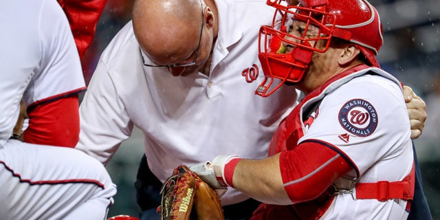Washington Nationals catcher Wilson Ramos (40) goes down with a knee injury during the 6th inning of a baseball game at Nationals Park in Washington, Monday, Sept. 26, 2016. (AP Photo/Andrew Harnik)