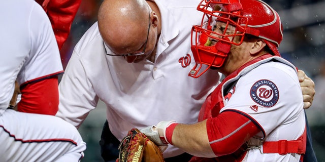 Washington Nationals catcher Wilson Ramos (40) goes down with a knee injury during the 6th inning of a baseball game at Nationals Park in Washington, Monday, Sept. 26, 2016. (AP Photo/Andrew Harnik)