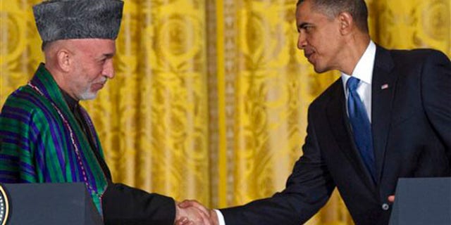 President Obama shakes hands with Afghan President Hamid Karzai during a news conference at the White House on May 12. (AP Photo)