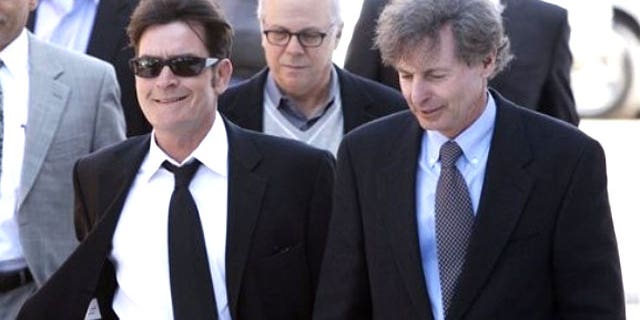 Charlie Sheen (left) and his lawyer leave a court hearing.