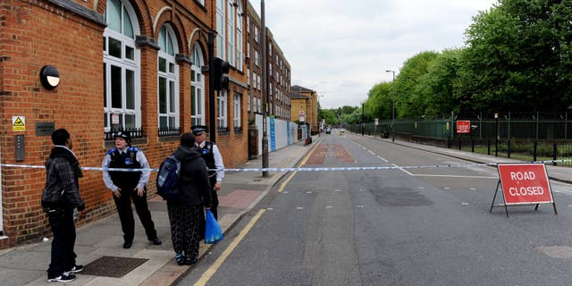 Artillery Place road is closed in Woolwich southeast London near the scene where British officials said one person has died and at least two people have been wounded in an attack on Wednesday May 22, 2013. (AP Photo/Nick Ansell/PA) UNITED KINGDOM OUT