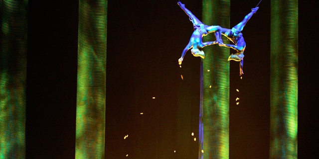 In this Nov. 28, 2008, photo, Sarah Guyard-Guillot, left, and Sami Tiaumassi perform as "Forest People" during Cirque du Soleil's "Ka" at MGM Grand Resort in Las Vegas. Guyard-Guillot, a mother of two young children, was pronounced dead at a hospital late Saturday night, June 29, 2013, after falling about 50 feet from the show's stage during a performance of Cirque du Soleil's "Ka."