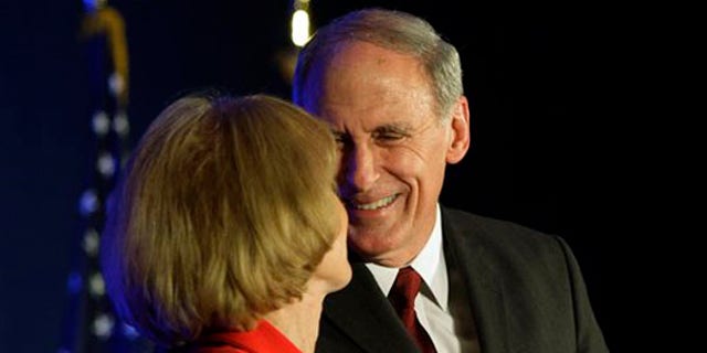 Sen. Dan Coats is greeted by his wife, Marsh, in Indianapolis.