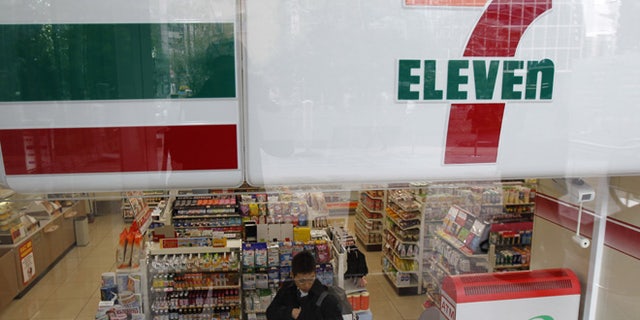 A customer is seen at a Seven-Eleven convenience store in Tokyo December 22, 2010.