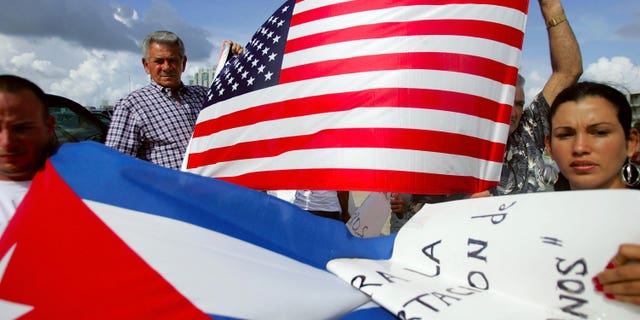 MIAMI - JULY 11: Oridio Conde (L) and Laura Hernandez participate in a protest July 11, 2006 in Miami, Florida. The protest was being held by relatives and friends of the Cubans involved in this past weekend?s interdiction at sea by the U.S. Coast Guard. They want the U.S. government to allow their relatives who are being held on a Coast Guard cutter to be allowed into the United States. One person died and four others were injured when their boat ignored orders to stop by the Coast Guard. (Photo by Joe Raedle/Getty Images)