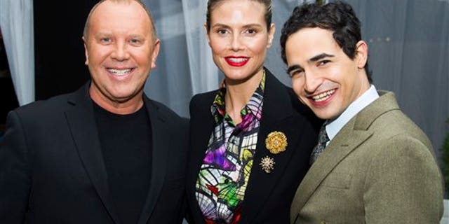 Michael Kors, from left, Heidi Klum and Zac Posen pose before the Fall 2013 Project Runway fashion show on Friday, Feb. 8, 2013 in New York. (Photo by Charles Sykes/Invision/AP)