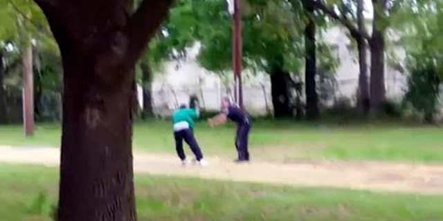 In this image from video, Walter Scott struggles with police officer Michael Thomas Slager in Charleston, S.C., on April 4, 2015. Moments later, the video shows Slager firing eight shots at Scott's back. Scott's death was shown around the world and he became a symbol of the ongoing debate over police shootings of unarmed African-Americans. (Feidin Santana via AP Images)