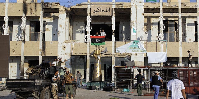 August 23: Rebel fighters seen inside the main Muammar Qaddafi compound in Bab al-Aziziya in Tripoli, Libya.