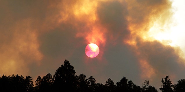 June 14: The sun sets behind smoke from the Wallow fire in Luna, N.M. The focus of the battle against the massive wildfire burning in eastern Arizona was on New Mexico as crews continued to light fires around the town of Luna to stop the flames.