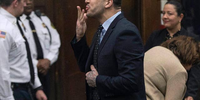 FILE - In this Wednesday, April 12, 2017, file photo, former New England Patriots tight end Aaron Hernandez blows a kiss to his daughter, who sat with her mother, Shayanna Jenkins Hernandez, Hernandez's longtime fiancee, during jury deliberations in his double-murder trial at Suffolk Superior Court in Boston. Hernandez was acquitted of those crimes on Friday, but hanged himself in his prison early Wednesday, April 19, 2017, where he was serving a life sentence in the 2013 killing of semi-professional football player Odin Lloyd. (Keith Bedford /The Boston Globe via AP, Pool, File)