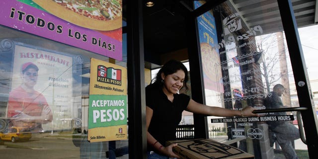 HOUSTON, TX - JANUARY 12: A customer leaves a Pizza Patron January 12, 2007, in Houston. The pizza chain now accepts Mexican pesos and U.S. dollars as payment. (Photo by Dave Einsel/Getty Images)