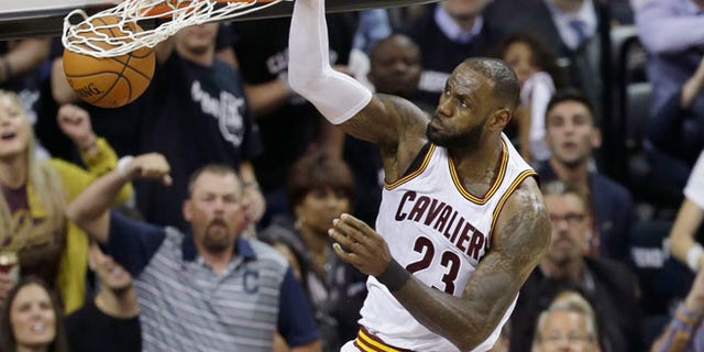 Cleveland Cavaliers forward LeBron James dunks against the Golden State Warriors during the first half of Game 4 of basketball's NBA Finals in Cleveland.
