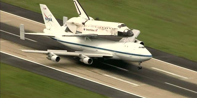 Thousands had packed the National Mall in front of the Capitol to watch the pair swoop by, as Discovery took a leisurely spin at an easy-to-spot 1,500 feet (450 meters) overhead prior to coming to a final rest.