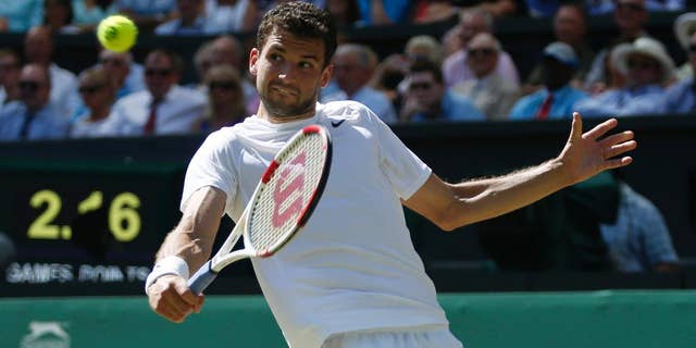 Grigor Dimitrov of Bulgaria plays a return to Novak Djokovic of Serbia during their men’s singles semifinal match at the All England Lawn Tennis Championships in Wimbledon, London, Friday, July 4, 2014. (AP Photo/Pavel Golovkin)