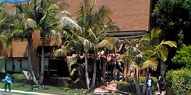 This image taken from cellphone video shows a building after a fatal explosion in Aliso Viejo, Calif., Tuesday, May 15, 2018. The cause of the blast is being investigated.
