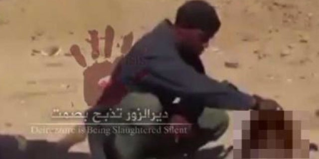 In this screengrab from a video believed to have been shot in November, Cuspert holds the severed head of a victim of ISIS (Raqqa is Being Slaughtered Silently)