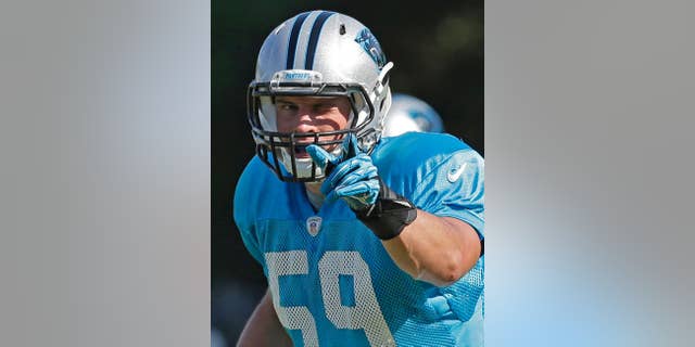 In this July 29, 2014, file photo, Carolina Panthers' Luke Kuechly (59) directs the defense during an NFL football practice at their training camp in Spartanburg, S.C. The AP’s Defensive Player of the Year in 2013, Kuechly is considered by Panthers coach Ron Rivera the team’s “defensive quarterback” on the field. (AP Photo/Chuck Burton)