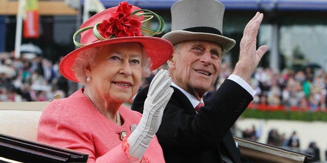 In this June, 16, 2011 file photo Britain's Queen Elizabeth II with Prince Philip arrive by horse-drawn carriage in the parade ring on the third day, traditionally known as Ladies Day, of the Royal Ascot horse race meeting at Ascot, England.