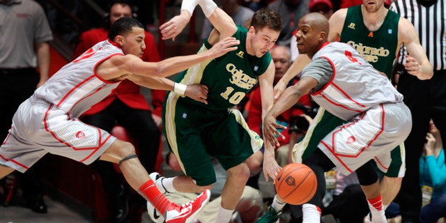 Colorado State's Wes Eikmeier (10) fights through the defense of New Mexico's Kendall Williams, left, and Chad Adams in the first half of their NCAA basketball game in Albuquerque, N.M., Wednesday, Jan. 23, 2013. Colorado State's Pierce Hornung, behind right, watches the play. (AP Photo/Eric Draper)