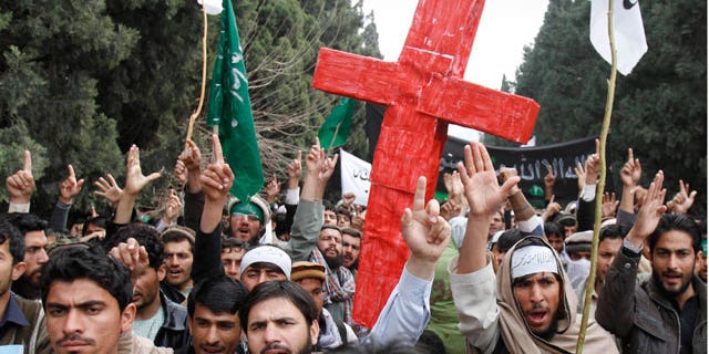 Mar. 13, 2012: Demonstrators chant anti U.S. slogans as they carry a red cross following Sunday's killing of civilians in Panjwai, Kandahar by a U.S. soldier during a protest in Jalalabad east of Kabul, Afghanistan.