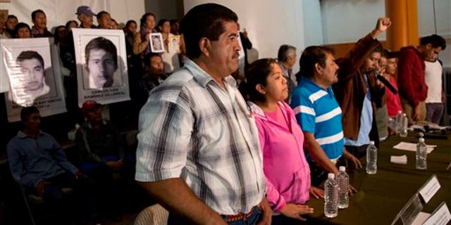 Parents of missing students, some holding pictures of the missing, attend the press conference after a meeting with Mexico's President Enrique Pena Nieto in Mexico, City, Wednesday Oct. 29, 2014. President Enrique Pena Nieto met with parents of 43 teachers college students Wednesday for the first time since they disappeared over a month ago, when investigators say police detained the students and handed them over to a drug gang. (AP Photo/Eduardo Verdugo)