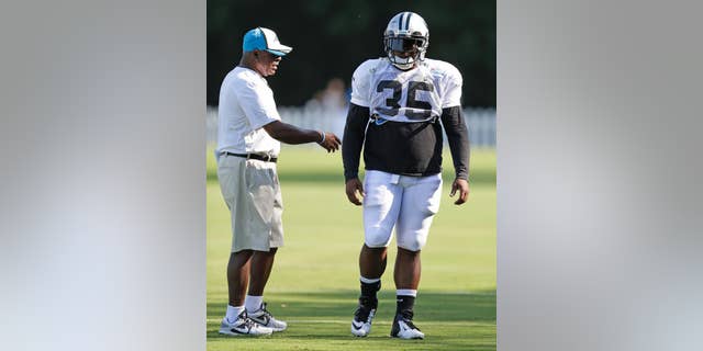 Carolina Panthers' Mike Tolbert, right, talks with running backs coach Jim Skipper, left, during an NFL football practice at their training camp in Spartanburg, S.C., Monday, July 28, 2014. (AP Photo/Chuck Burton)