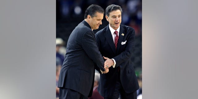 FILE - in this March 31, 2012, file photo, Louisville head coach Rick Pitino, right, shakes hands with Kentucky head coach John Calipari before the first half of an NCAA Final Four semifinal college basketball tournament game in New Orleans. Kentucky has fallen out of the Top 25 and the defending national champs are still looking to establish themselves heading into the instate showdown with rival Louisville. The fourth-ranked Cardinals Saturday will try to end a four-game skid against the Wildcats. (AP Photo/David J. Phillip, File)