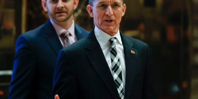 Retired Lt. Gen. Michael Flynn talks to media as he arrives at Trump Tower in New York, Nov. 17, 2016.