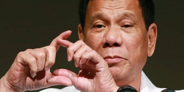 FILE - In this Oct. 26, 2016, file photo, Philippine President Rodrigo Duterte delivers a speech at the Philippine Economic Forum in Tokyo. Duterte telephoned U.S. President-elect Donald Trump late Friday, Dec. 2 and had a brief but "very engaging, animated conversation" in which both leaders invited each other to visit his country. In a video released by Duterte's close aide, Bong Go, the Philippine leader is seen smiling while talking to Trump late Friday and saying: "We will maintain ... and enhance the bilateral ties between our two countries." (AP Photo/Eugene Hoshiko, File)