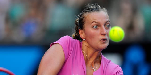 Petra Kvitova of the Czech Republic returns to Luksika Kumkhum  of Thailand  during their first round match at the Australian Open tennis championship in Melbourne, Australia, Monday, Jan. 13, 2014. (AP Photo/Andrew Brownbill)