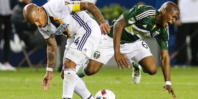 Los Angeles Galaxy midfielder Nigel de Jong, left, crashes into Portland Timbers midfielder Darlington Nagbe during the second half of an MLS soccer game in Carson, Calif., Sunday April 10, 2016. The game ended in a 1-1 draw. (AP Photo/Ringo H.W. Chiu)