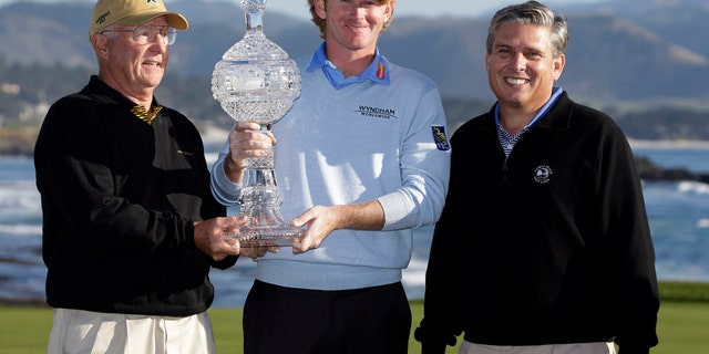 Brandt Snedeker poses with co-amateur champions Toby S. Wilt, left, and John Erickson, right, on the 18th green of the Pebble Beach Golf Links following the AT&T Pebble Beach Pro-Am golf tournament, Sunday, Feb. 10, 2013, in Pebble Beach, Calif. Snedeker won the tournament after shooting a 7-under 65. Wilt played with Snedker and Erickson was paired with Michael Letzig. (AP Photo/Eric Risberg)