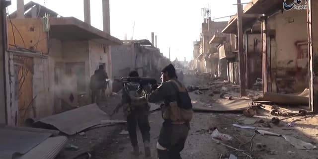 ISIS fighters during a gun battle in Deir el-Zour in 2015 in a photo released by the terror group's propaganda wing.
