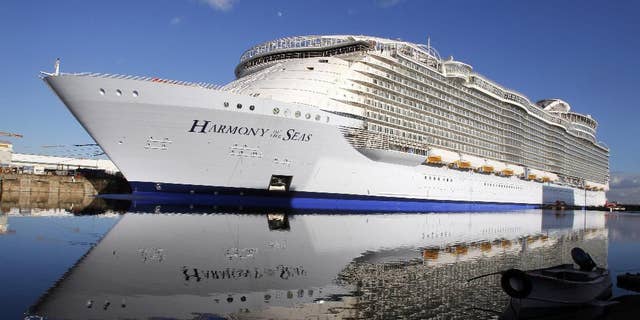 FILE- In this  Feb. 18, 2016 file photo, the "Harmony of the Seas" docks at the STX Shipyard in Saint-Nazaire, western France. Tens of thousands of French well-wishers waved revoir to the largest cruise ship in the world as it set sail on its maiden voyage to the U.K. after 32 months in a French shipyard. (AP Photo/Laetitia Notarianni, File)