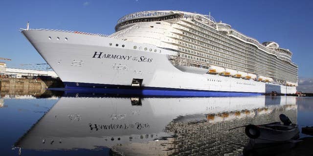FILE- In this Feb. 18, 2016 file photo, the "Harmony of the Seas" docks at the STX Shipyard in Saint-Nazaire, western France. Tens of thousands of French well-wishers waved revoir to the largest cruise ship in the world as it set sail on its maiden voyage to the U.K. after 32 months in a French shipyard. (AP Photo/Laetitia Notarianni, File)
