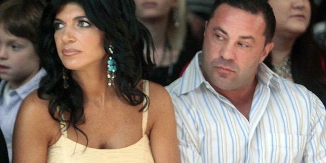 This Sept. 13, 2009 file photo originally released by Oral-B Pulsonic shows "Real Housewives of New Jersey" stars, Teresa Giudice, left, and her husband Joe Giudice at the Caravan Fashion Show in New York. Teresa and Giuseppe “Joe” Giudice were charged in a 39-count indictment handed up Monday, July 29, 2013, in Newark, N.J.