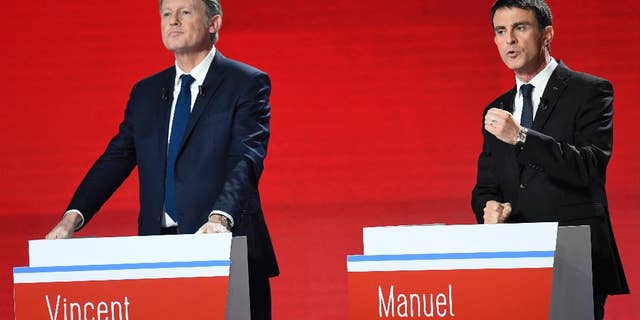 Candidates for the French left's presidential primaries ahead of the 2017 presidential election, Vincent Peillon, left, and Manuel Valls take part in the second televised debate in Paris, France, Sunday, Jan. 15, 2016. Seven competitors are bidding to be the Socialist Party's candidate in next spring's French presidential election. (Bertrand Guay/Pool Photo via AP)