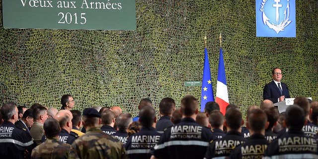 French President Francois Hollande delivers a speech during his visit to the French nuclear aircraft carrier Charles de Gaulle to present his New Year wishes to the French military troops, Wednesday, Jan. 14, 2015, off the coast of Toulon, southern France. France ordered prosecutors around the country to crack down on hate speech, anti-Semitism and glorifying terrorism and announced Wednesday it was sending an aircraft carrier to the Mideast to work more closely with the U.S.-led coalition fighting Islamic State militants. (AP Photo/ Anne Christine Poujoulat /Pool)
